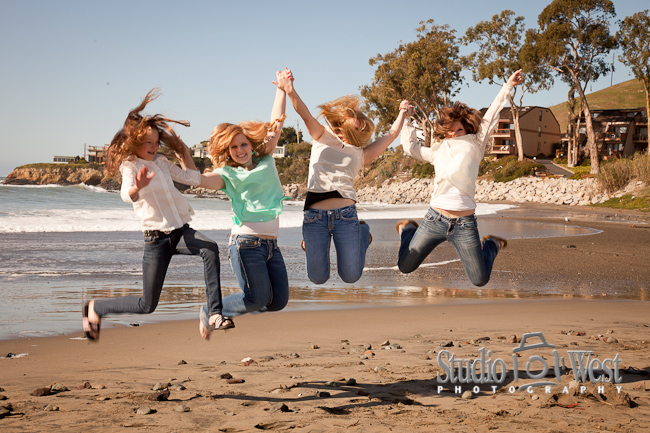 Jumping girl cousins at Cayucos Beach