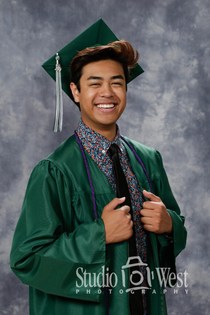 Studio portrait of a man in graduation cap and gown