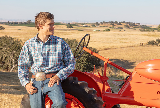 Senior Portrait with Tractor - FFA High School Senior Portrait - Orange Tractor Senior Portrait on Location - Studio 101 West Photography